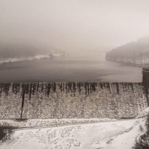 Derwent Dam Winter Print featuring the iconic twin towers  in the Peak District during snowfall.